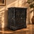 A richly detailed antique cast iron fireplace insert with intricate openwork and a deep black finish. A statement piece...