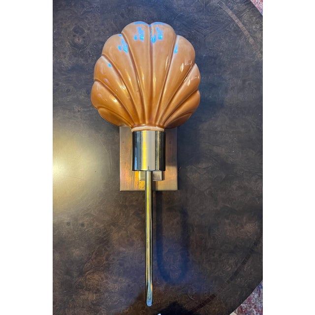 A striking vintage wall sconce executed in the glamorous Coastal Hollywood Regency taste of the late 1970s and 1980s. The...
