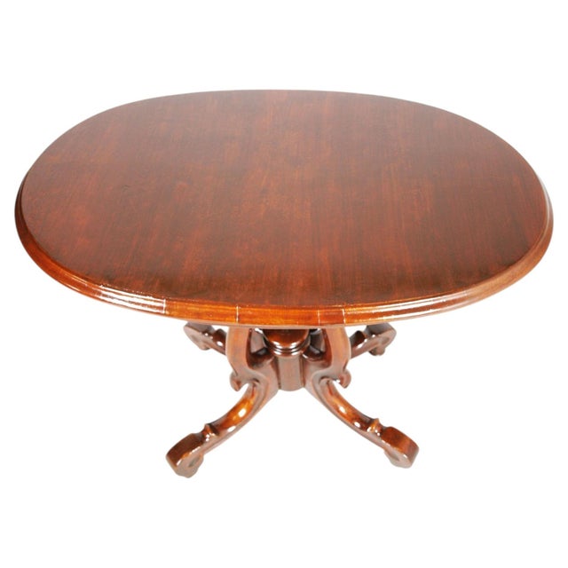 Refined Italian oval side table from the 1930s, crafted in solid walnut and executed in the elegant style of Paolo Buffa....