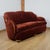 An art deco 'cloud' sofa by harry & lou epstein. Figured walnut banding. Re-upholstered in burgundy fabric. Dimensions: h...