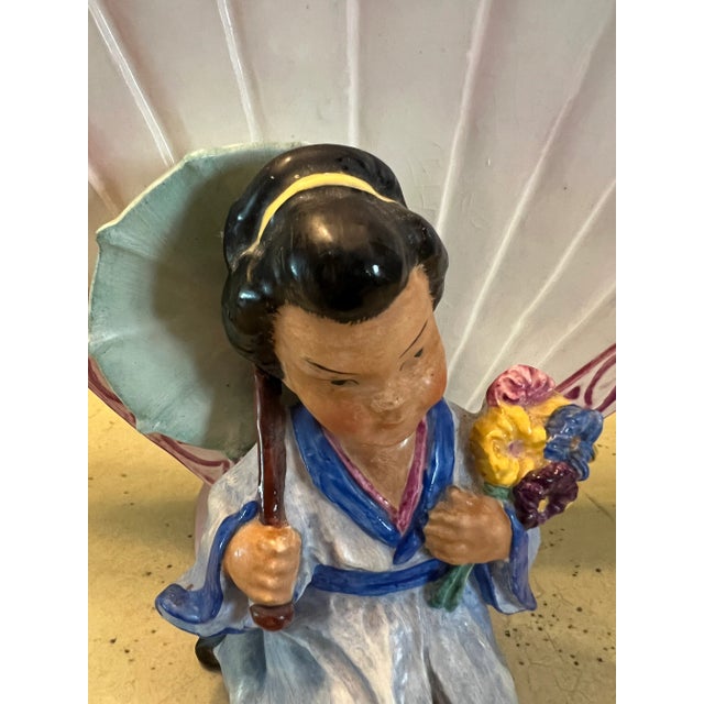 Asian vase made by Goebel Erphila which was made in Germany in the 1930s. The fan is trimmed in pink with a kneeling...