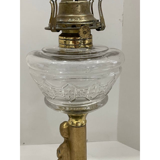 The 19th Century Figural Cherub Oil Lamp is a vintage piece with a unique design featuring a cherub and doves symbolizing...