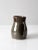 This is a vintage studio pottery mug. Signed by the artist, the handmade hand-warmer mug features an inset handle and...