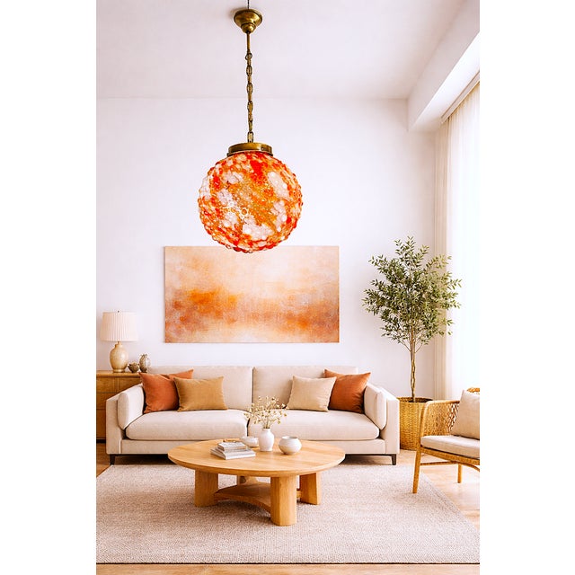 More than a fixture, this large round pendant is a statement of atmosphere. Its sculptural, mid-century modern form casts...