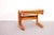 This is a set of three Scandinavian modern teak nesting tables. The tables are made of solid teak and have rounded edges.
