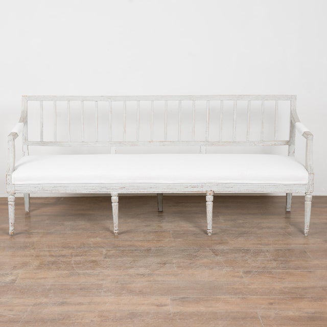 This lovely 6' long bench is a wonderful example of Swedish Gustavian craftsmanship with it's fluted carved skirt and back...