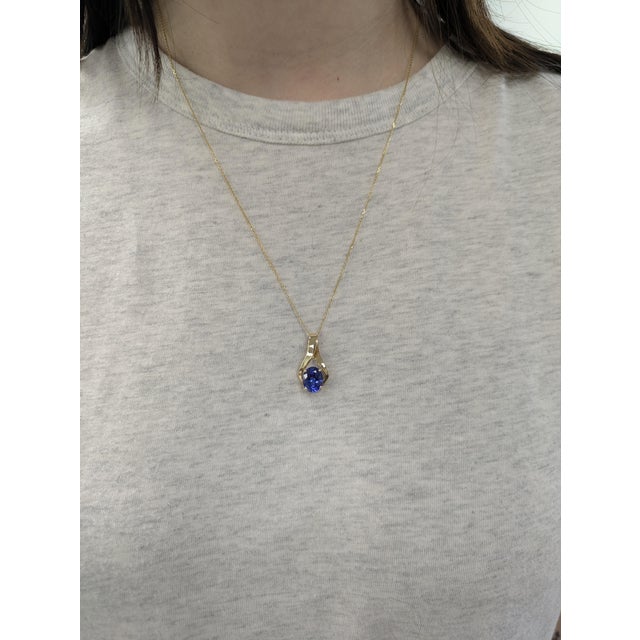 This elegant solitaire Estate pendant features a 2.51ct oval-shaped Tanzanite , measuring 10x8mm and heat-treated to...