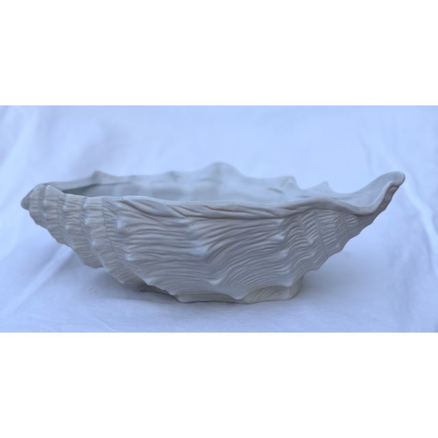 California coastal chic! This white porcelain bowl/planter in the shape of a conch shell has such intricate detailing you...