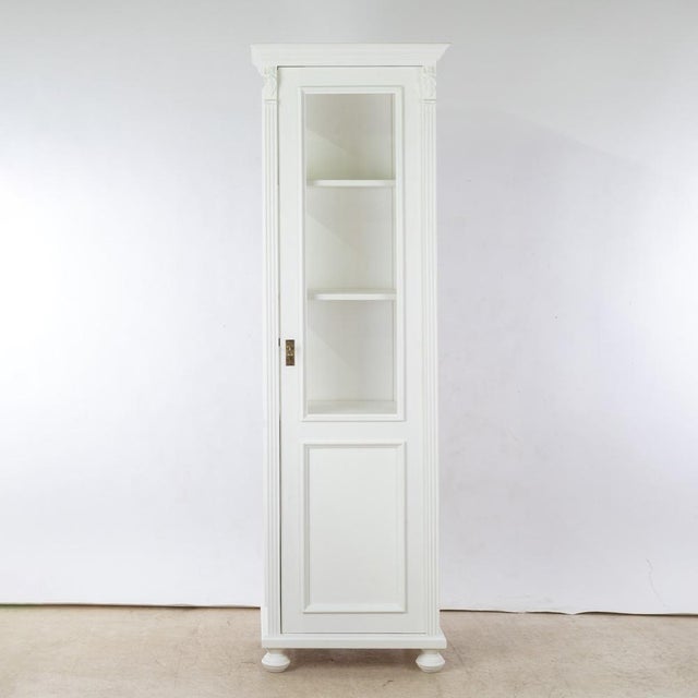 This display cabinet is a sleek, upright storage unit made of solid pine and part of our series of high-quality softwood...