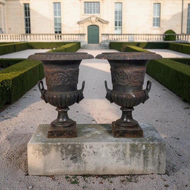 This pair of French cast iron Campana garden urns was produced in France during the Late 19th Century. Cast in heavy iron,...