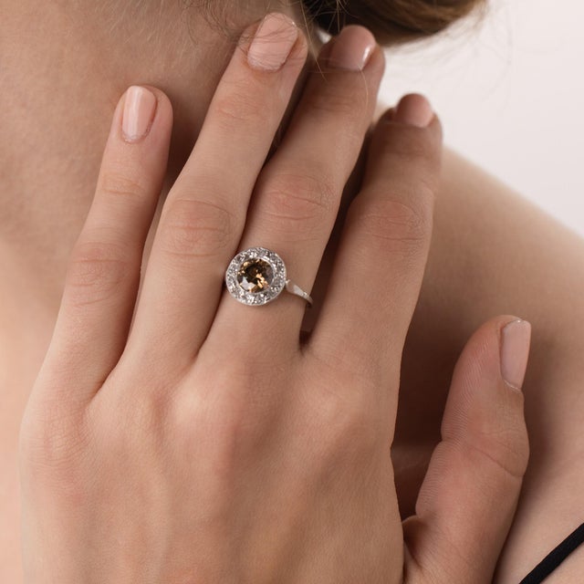This beautiful French Art Deco diamond engagement ring is a distinctive 1920’s design, centered by a GIA-certified round...