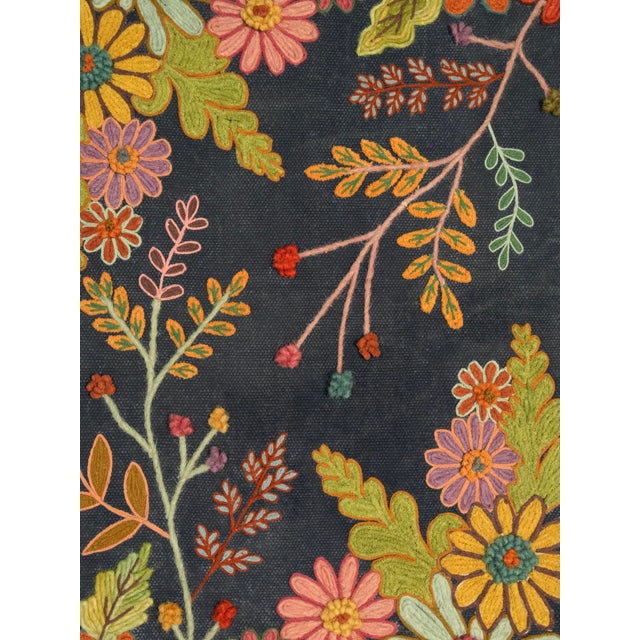 Add a touch of nature-inspired charm to your home with this hand-embroidered floral wall frame. Featuring vibrant flowers...