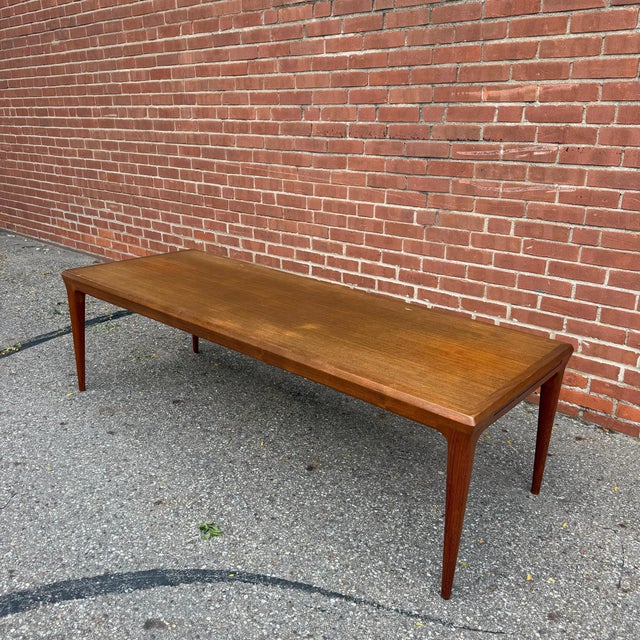 Designed by Johannes Andersen, this Danish modern coffee table pairs clean, sculpted lines with thoughtful functionality....