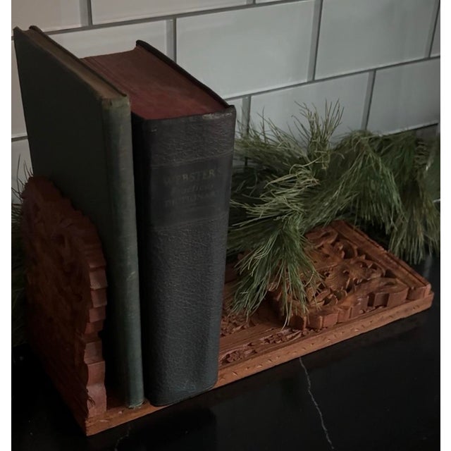 Hand-carved hardwood expandable novel rest from India, mid-20th century. The form features hinged end supports and...