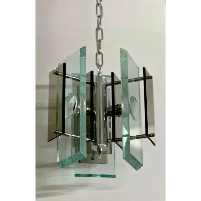 Beautiful vintage Italian pendant with clear and smoky Murano glass mounted on a chrome frame. Made in Italy, c. 1970's....