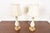 A gorgeous pair of Hollywood Regency porcelain and brass table lamps By Lenox Lighting by Quoizel Circa Late 20th Century...
