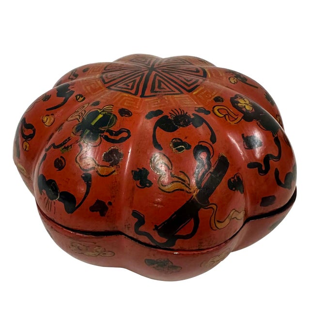 This item is an antique Chinese lacquer trinket box in a pumpkin shape. It mad of carved wood coated in multiple layers of...