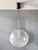 Beautiful vintage pendant light with an imposing globe of clear blown glass, riddled with numerous air bubbles trapped...