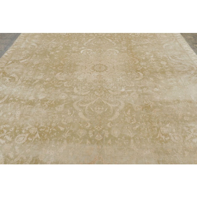 Made with hand-knotted wool and originating circa 1900-1920, this 10x14 oversized antique Persian Tabriz rug represents a...
