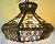 Fabulous vintage mid century chandelier. Very ornate with a gold wrought iron scroll design and amber stained glass...