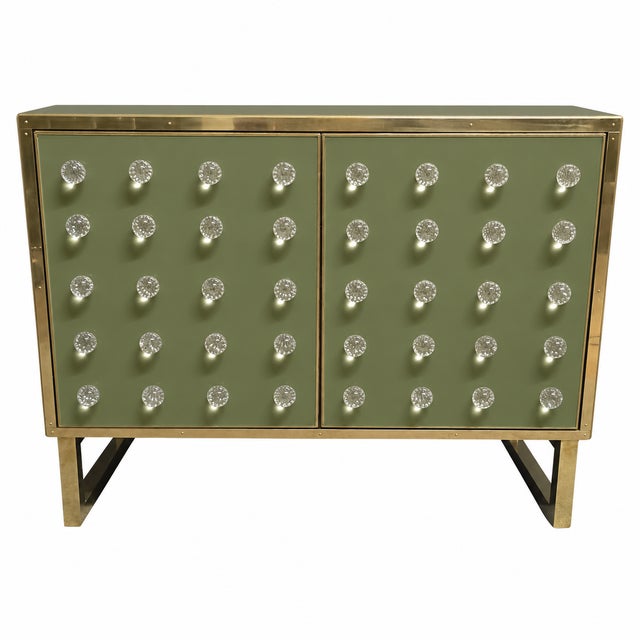 An olive-green finish softens the graphic front of this Italian dry bar while forty clear Murano glass spheres add light...