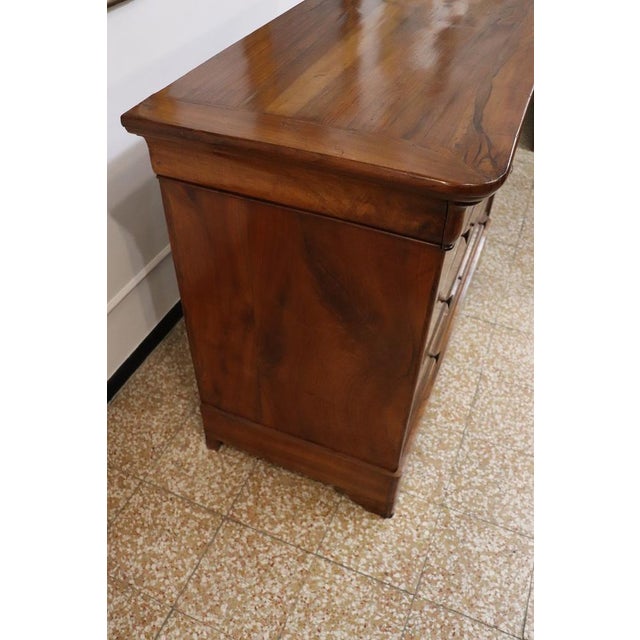 This exquisite mid-19th century Italian antique chest of drawers exemplifies timeless craftsmanship and elegant design....