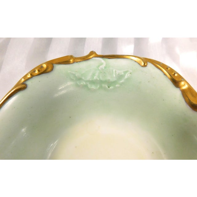 This is a pale green long oval serving bowl by Jean Pouyat Limoges. The bowl is signed. The backstamp is dated 1890 to...