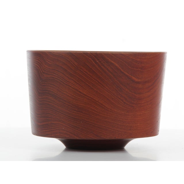 This handcrafted bowl is made of solid teak.