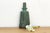 This heavy-cast bronze bell is a remarkable study in archaic ritual design, featuring the characteristic "ni" (bosses) and...