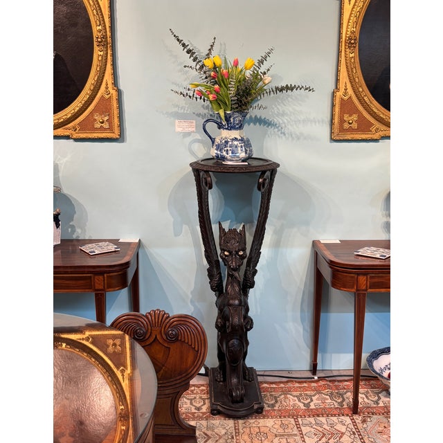 Large hand-carved pedestal in ebonized oak featuring a majestic Dragon Gargoyle with a baleful stare. Italy, Mid-19th...