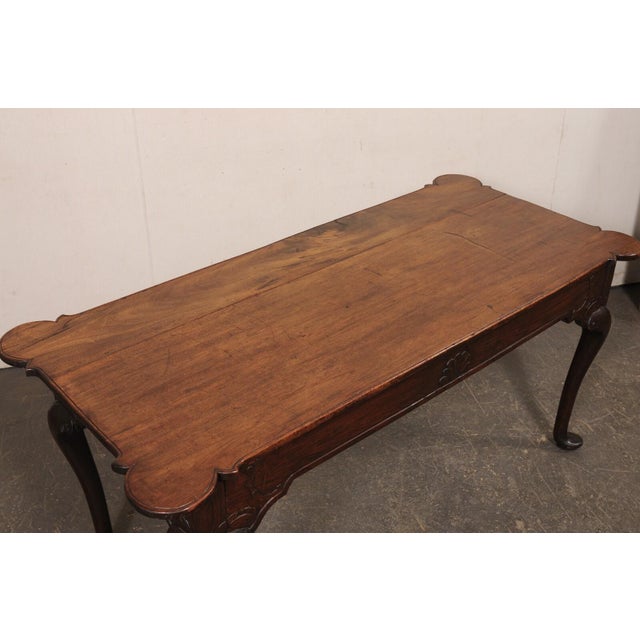A handsome Portuguese carved-walnut console table, with carved apron and nicely profiled top corners, from the 18th...