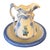 An exceptionally decorative early 20th-century ceramic wash basin and pitcher set in soft ivory and periwinkle blue. The...