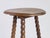 A small antique wooden side table with bobbin style legs made in France. The table has a a round top and is hand made. The...
