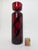 Ruby-red, mouth-blown cylindrical vase with spirally arranged black overlay stripes. Stelvia Glass was founded in the...