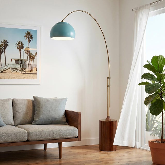 Weathered Brass steel paired with a Dark Walnut wood base defines the Tambo Arc Lamp, a Mid-Century Modern masterpiece...