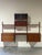 Impressive Danish Mid-Century Modern modular wall unit crafted in warm teak and dating to the 1960s. This versatile wall-...
