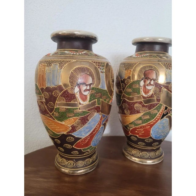 Pair of satsuma terracotta vases, hand decorated with enamels.