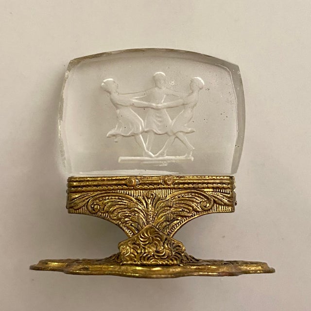 These vintage place card holders feature clear intaglio-carved glass inserts depicting dancing figures mounted on ornate...