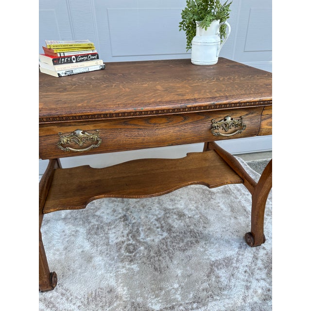 Beautiful Victorian tiger oak antique table. One long drawer with original pulls, dovetail joinery and lovely carved lower...