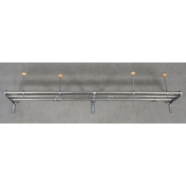 Swedish functionalistic coat rack made in the 1930-1940. Aluminum holders and hangers on beech wood bars.The length is...