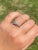 The Lake Mystic: Past Present Future Three Stone Bypass Ring. The ring features three round brilliant cut diamonds four...
