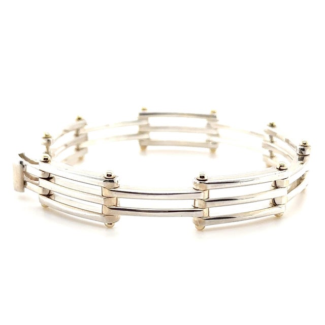 A distinctive vintage Tiffany & Co. Gate Link bracelet combining sterling silver with 18ct yellow gold, featuring a...