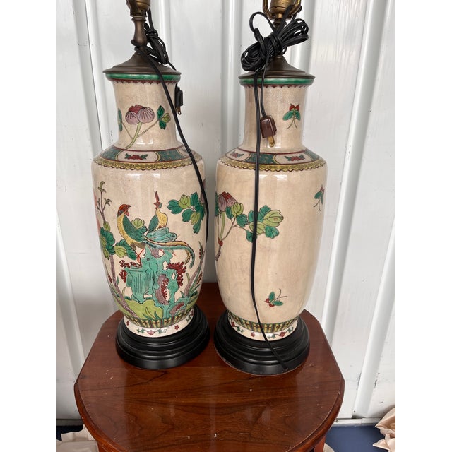 Pair of vintage Chinese Crackle porcelain vase lamps on black wooden bases. Each lamp measure 39.5" to tip of finial....