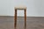 An English petite oak stool from the 19th century featuring custom linen upholstery and turned legs. The stool is...