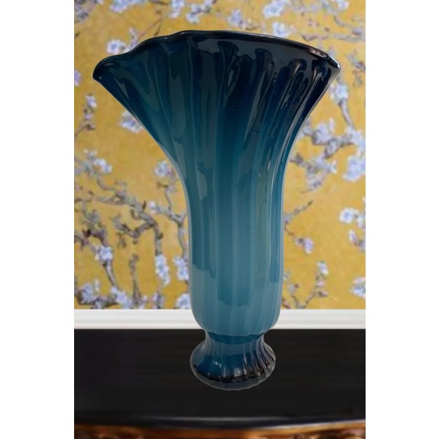This exquisite 12 1/2-inch tall vase is a stunning example of hand-blown glass artistry, showcasing a masterful blend of...