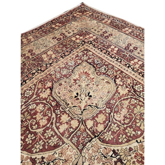 This master crafted Persian Laver Kerman carpet exemplifies the profound understanding of the artistic principles of...