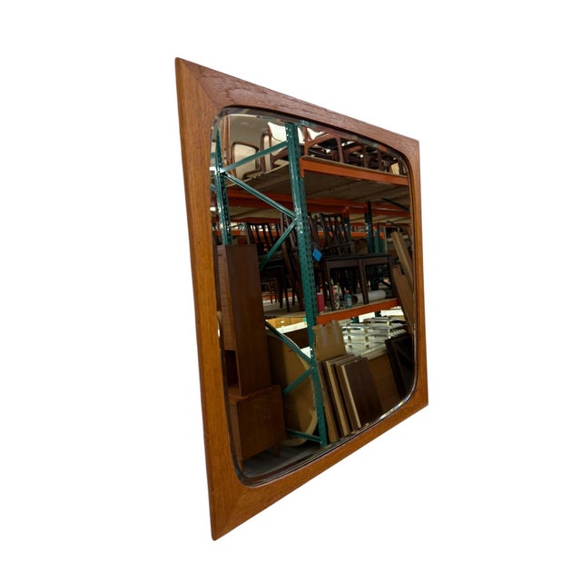 Elevate your space with this authentic 1960s Danish Modern teak wall mirror, a warm, minimalist accent perfect for any...