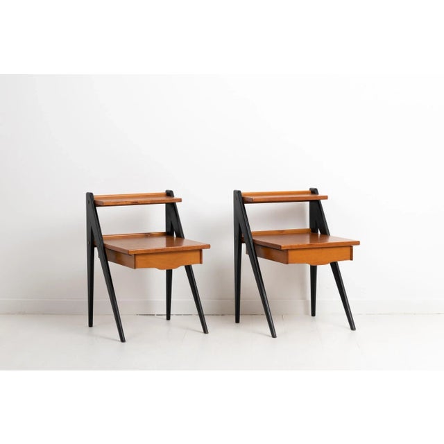 Scandinavian modern nightstands in teak with blackened legs designed by Yngve Ekström. The nightstands are from Sweden and...