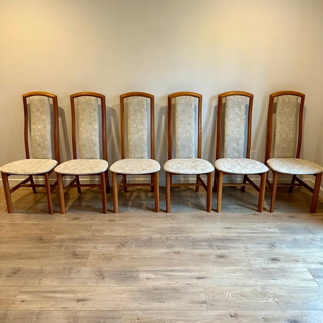 Set of six solid teak high back dining chairs, made in Denmark by Skovby c. 1990s. The DC54T has an ergonomically curved...