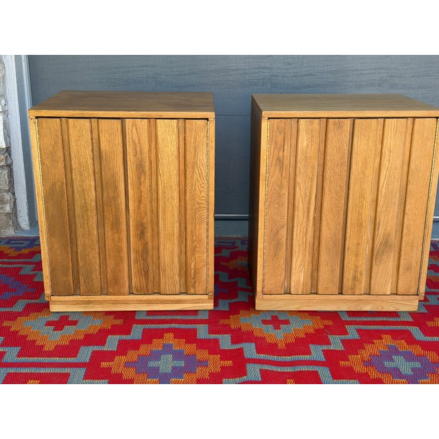 Beautiful Danish Modern Oak Cabinets by Sligh Furniture from the 1950s, featuring a clean slatted front that opens to...